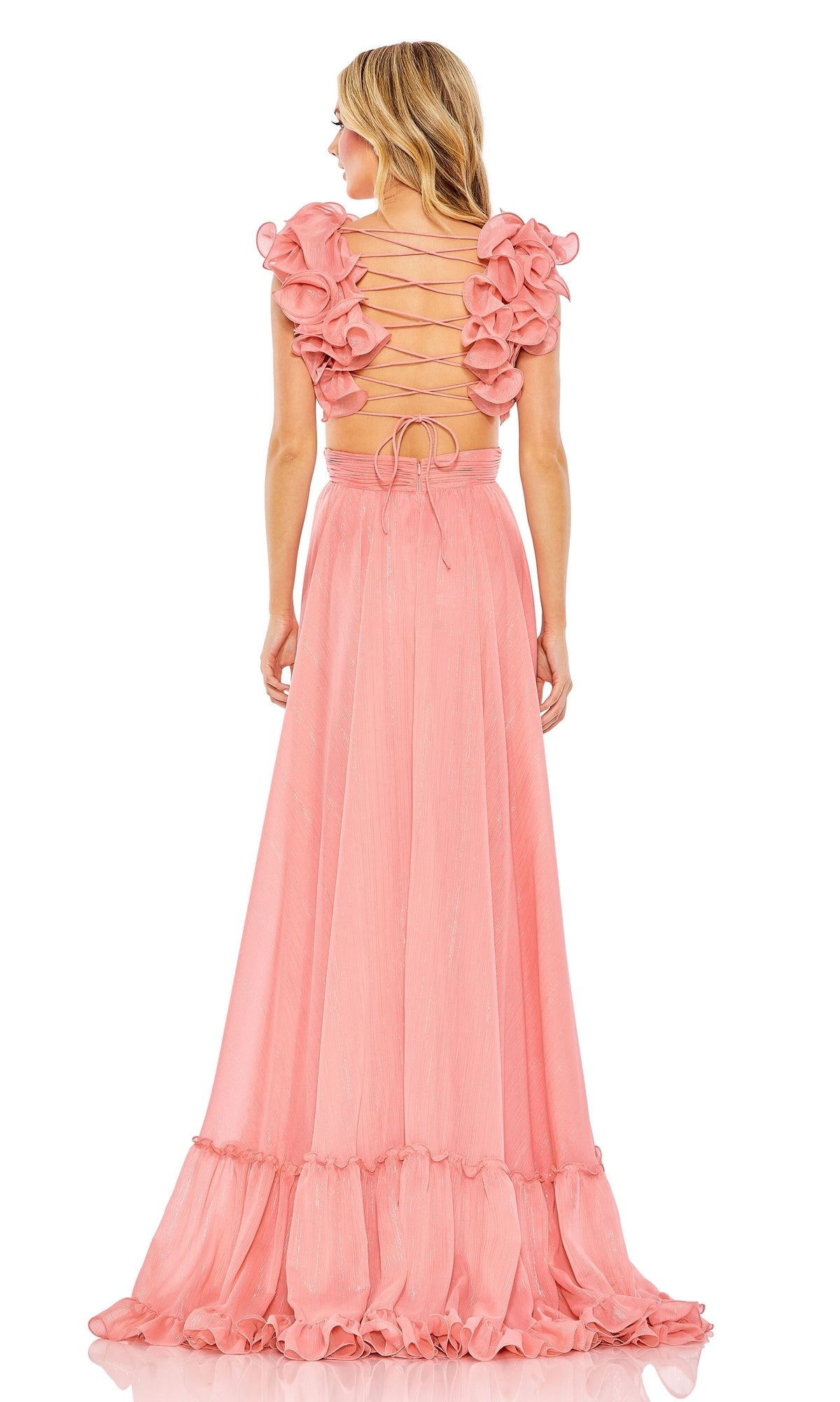 Woman wearing the Mac Duggal 68094 Lace-Up Ruffled Formal Gown, a sleeveless, floor-length pink dress with ruffled shoulders and an open lace-up back, standing and facing away from the camera.